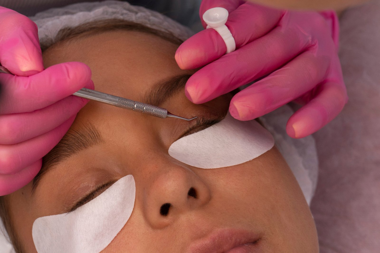 Professional technician applying eyelash extensions